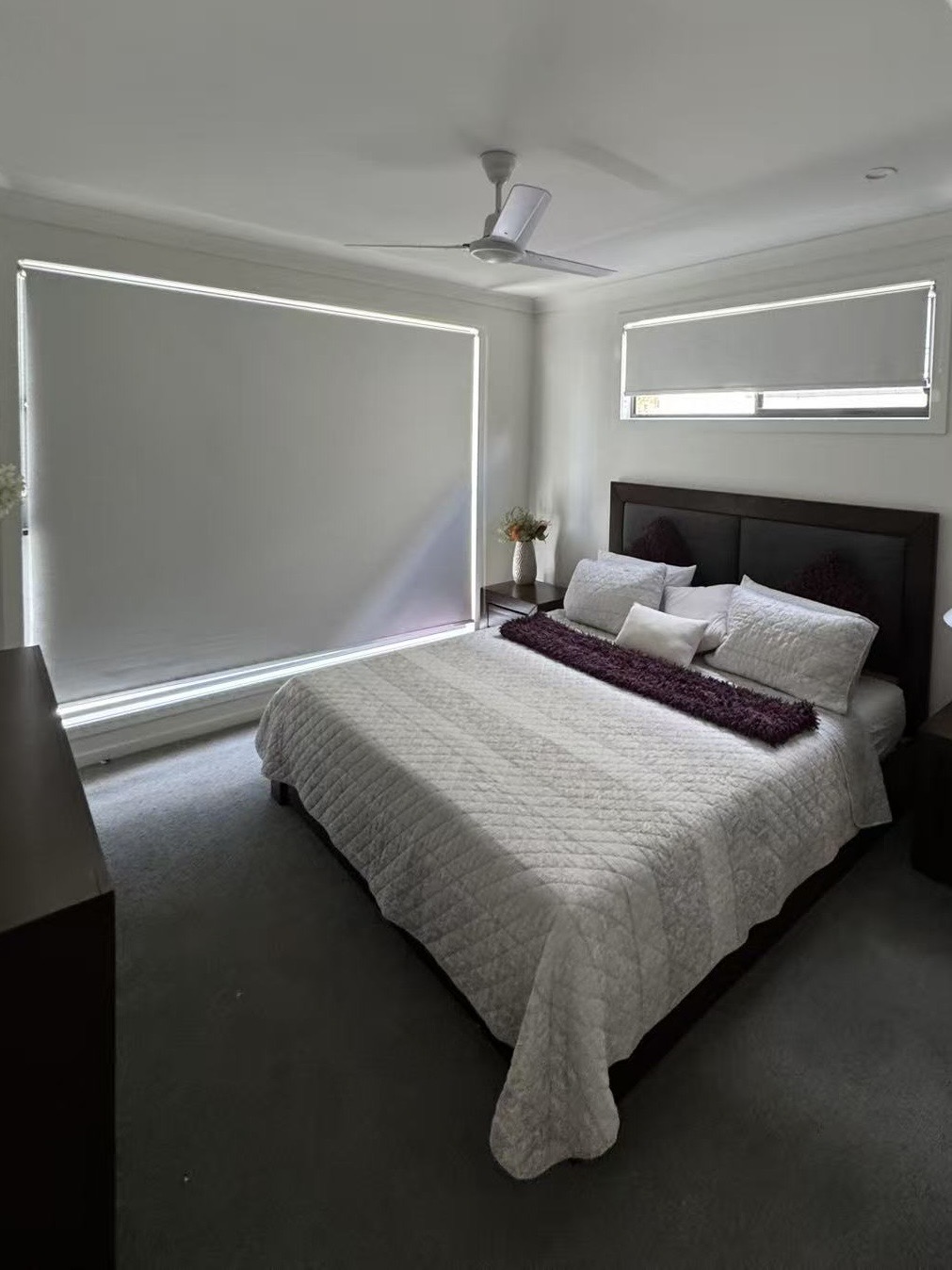 White blockout roller blinds installed in the bedroom