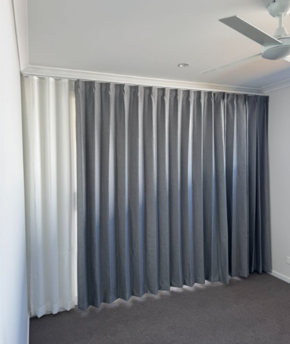 Pinch blockout curtain with S-fold privacy sheer installed for bedroom window