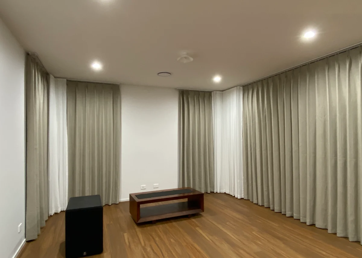 S-fold sheers with pinch blockout curtains installed for the living areas windows