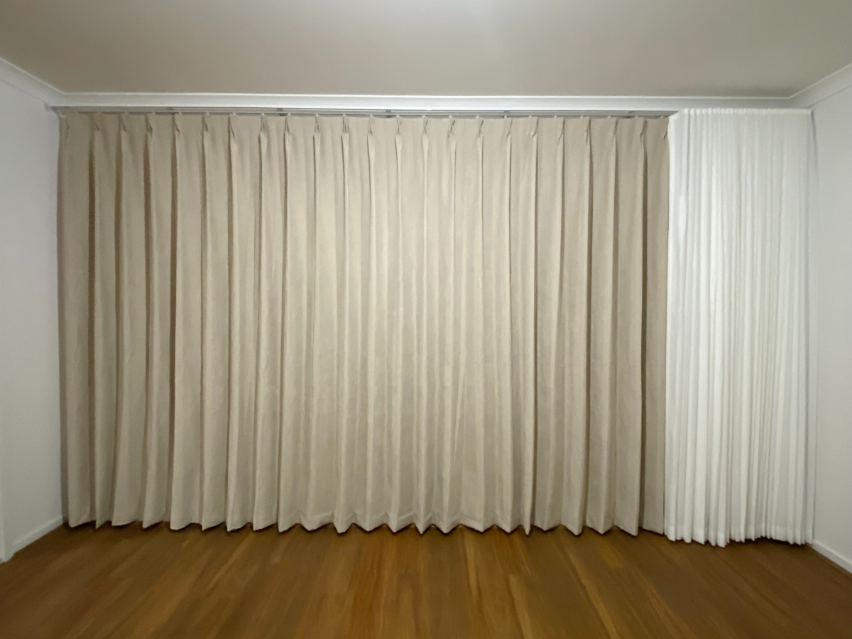 S-fold sheer with pinch blockout curtain installed for one window