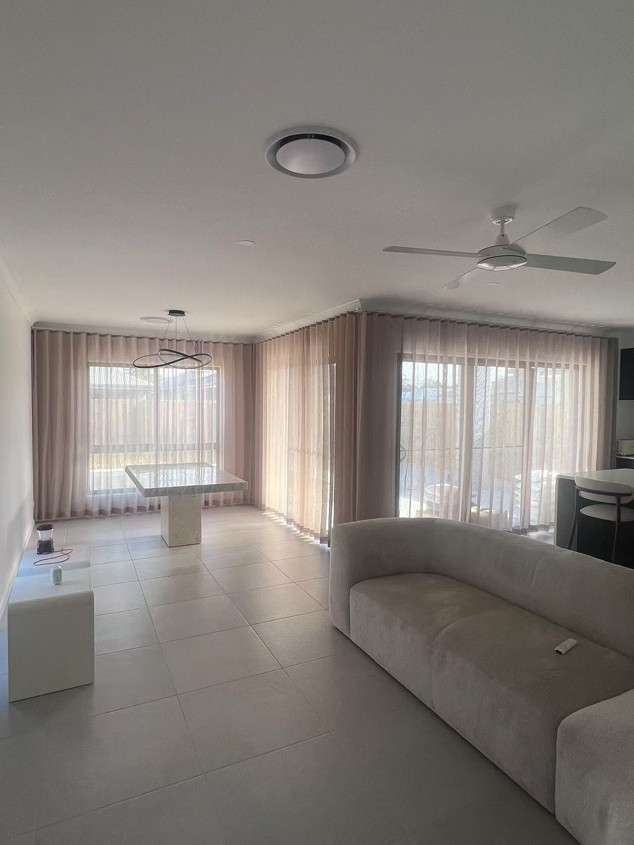 Light brown S-fold sheer installed for living room window and sliding door