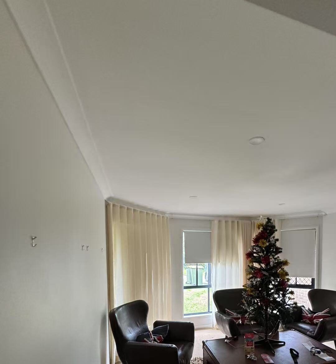 S-fold sheer with grey blockout roller blinds installed for by windows in activity area