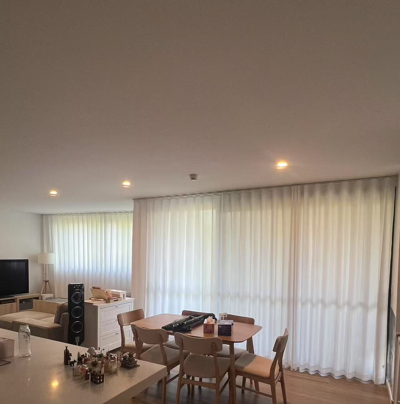 S-fold privacy sheers installed in the dining and living area