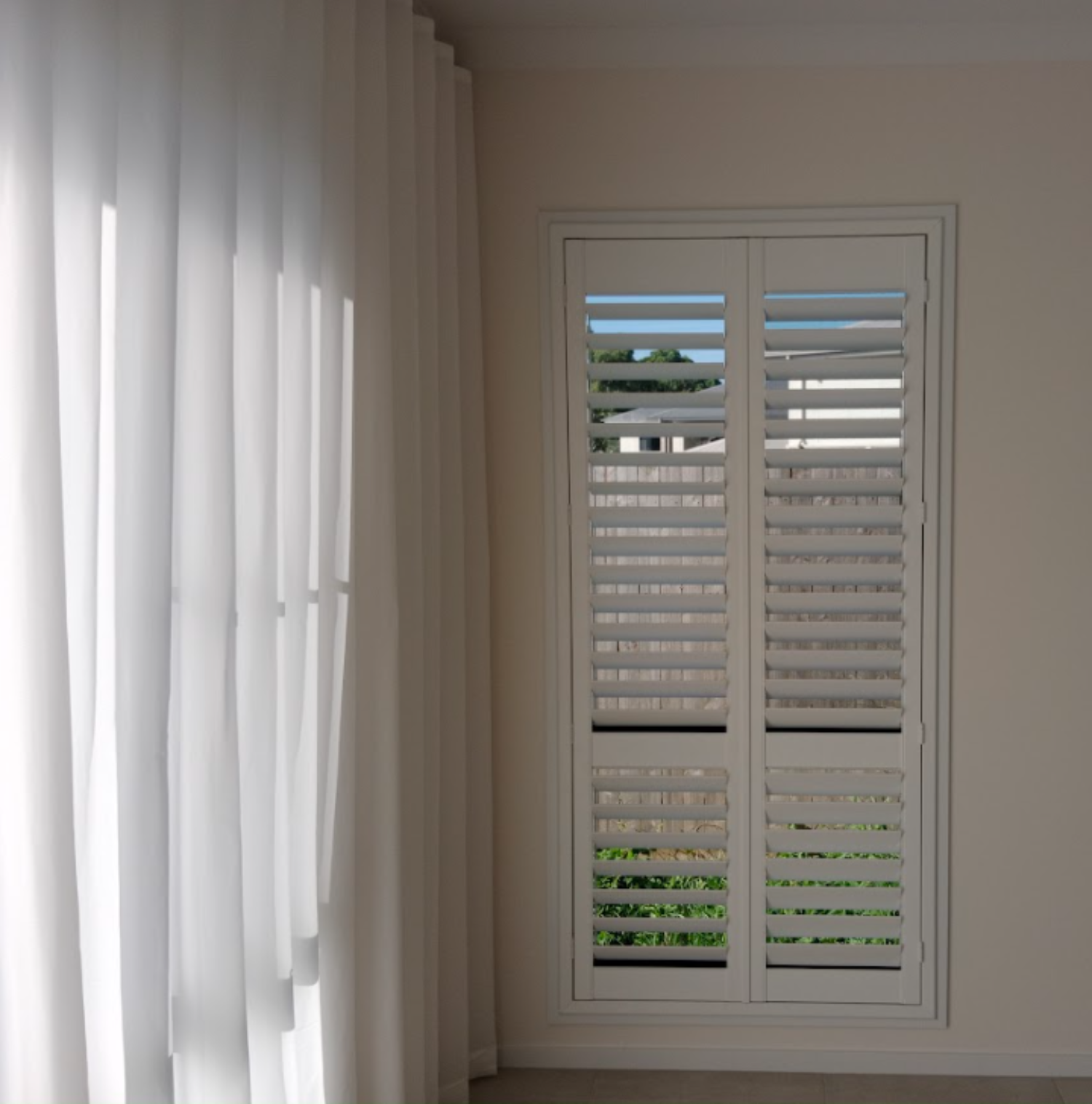 PVC plantation shutter and S-fold sheer installed in bedroom