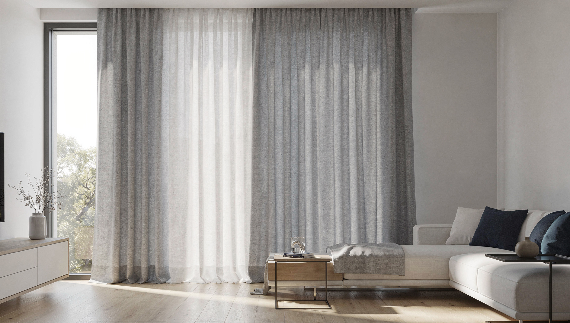Made-to-measure curtains tailored to fall perfectly to the floor across a wide living room window