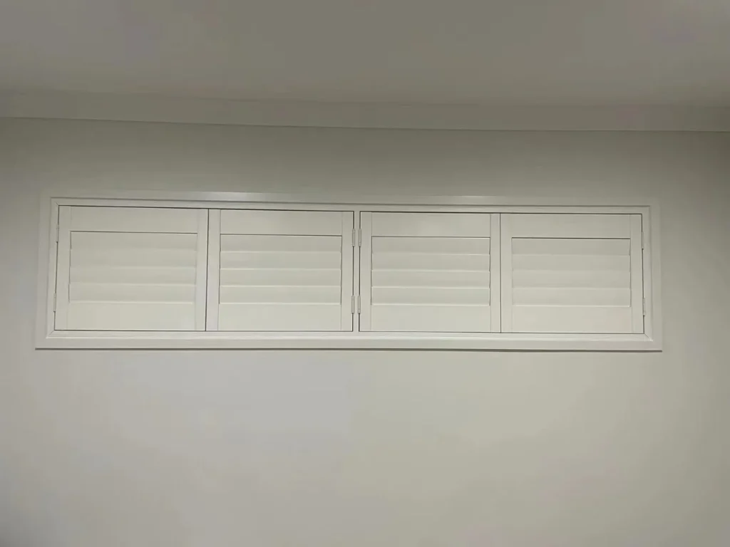 White PVC shutters elegantly installed on a narrow window.
