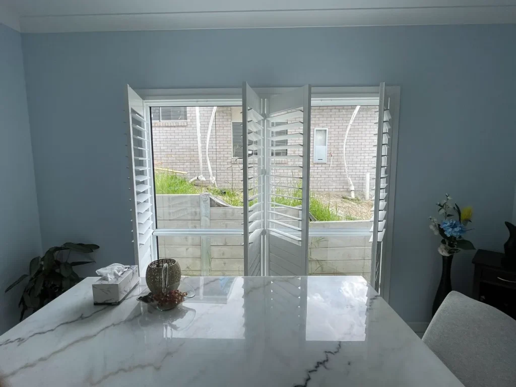 White PVC shutters elegantly installed in a dining room