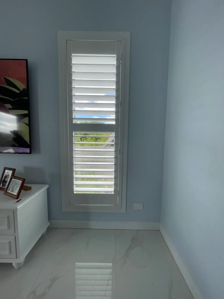 White PVC shutters elegantly installed in a living room.