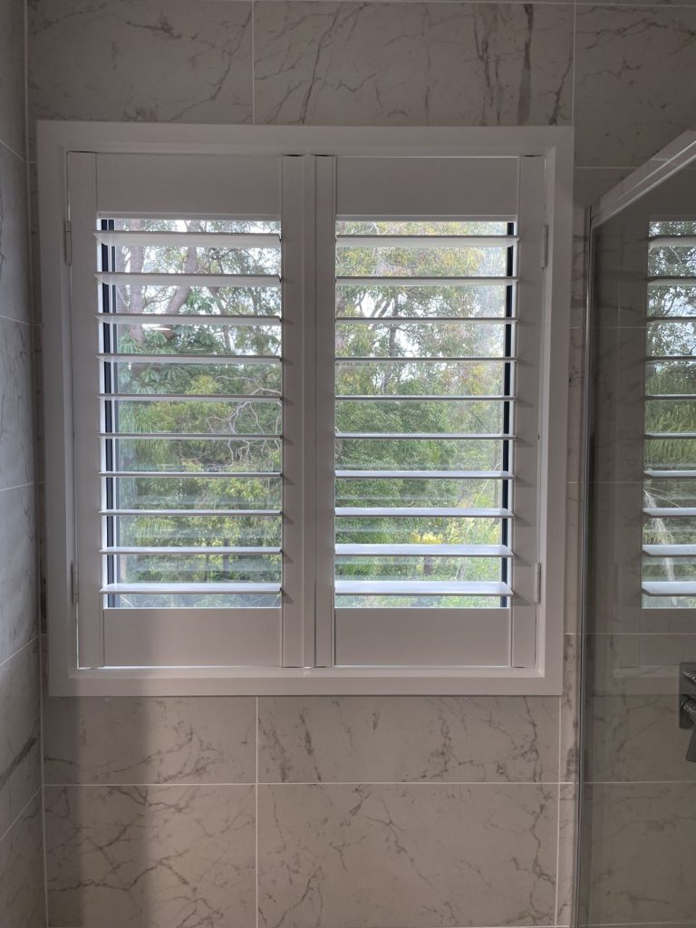 White PVC shutters elegantly installed in a bathroom