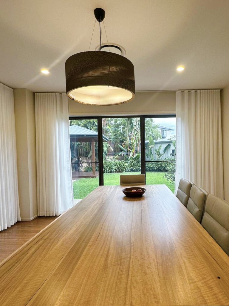 S-fold privacy sheers elegantly installed in a dining room.