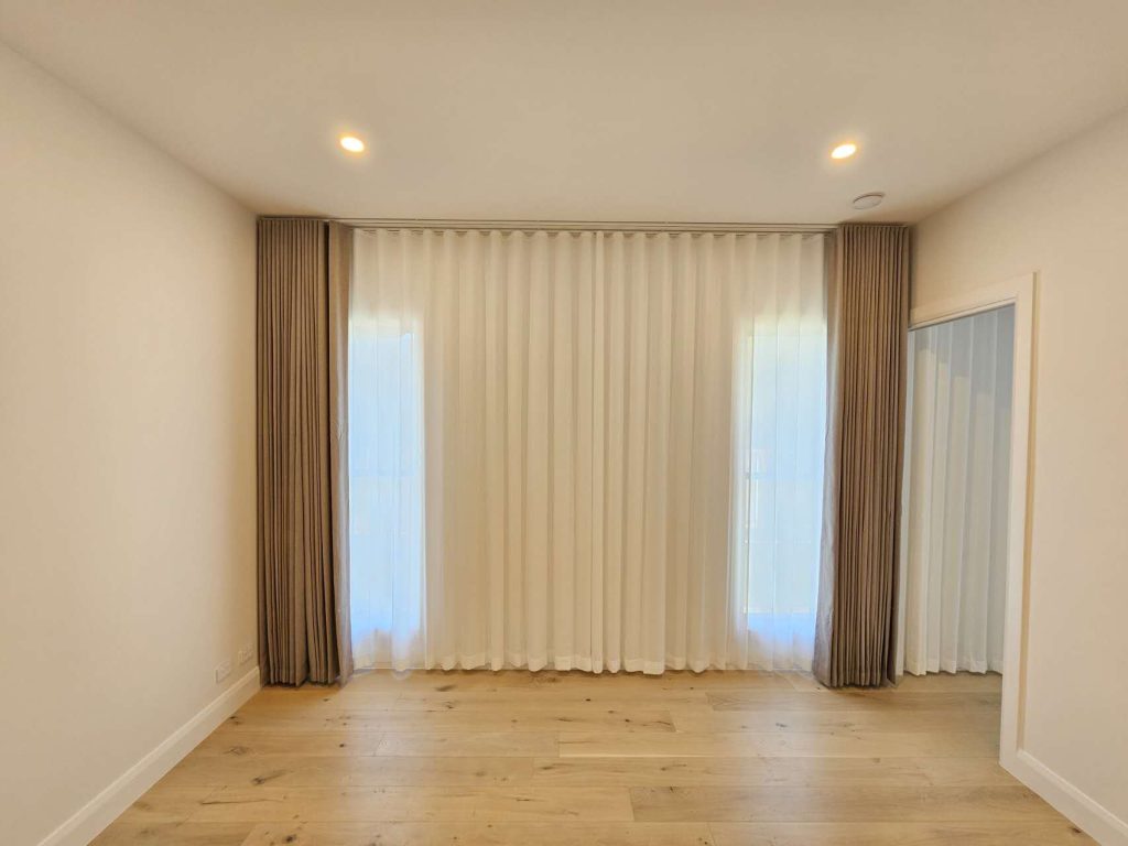 Brown S-fold curtains paired with privacy sheers in a stylish interior.