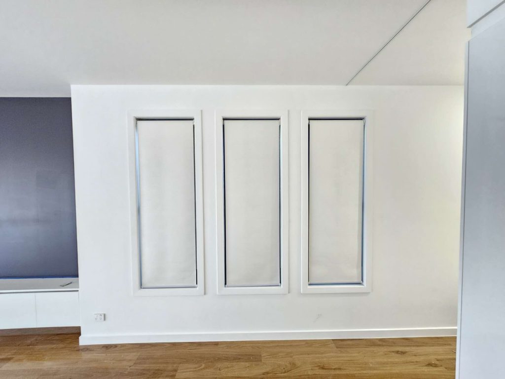 White blockout roller blinds elegantly installed in a living room.