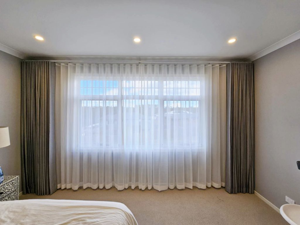 Grey S-fold curtains paired with S-fold transparent sheers