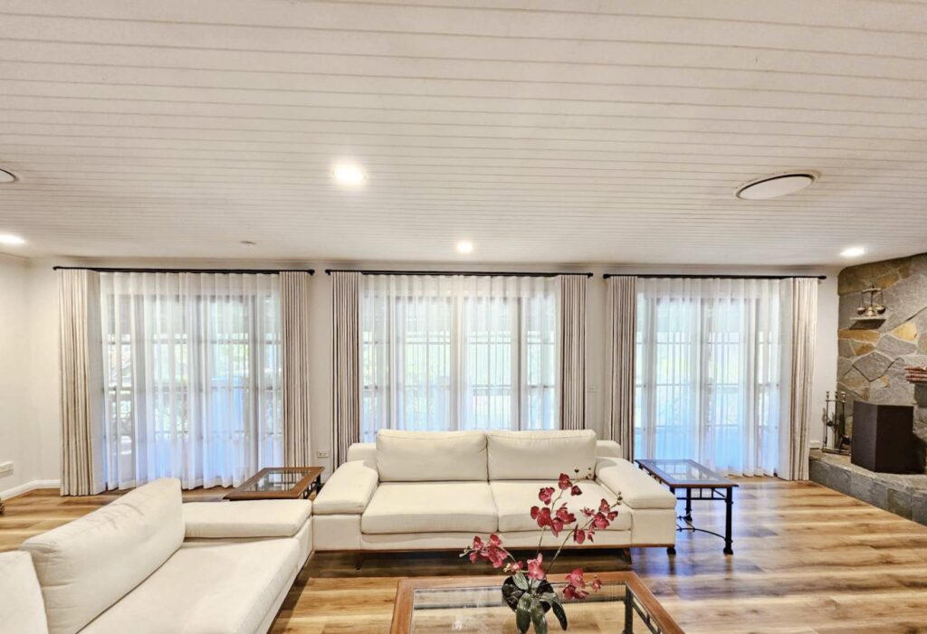 Image of stylish S fold curtains paired with sheer fabric, creating an elegant window treatment.