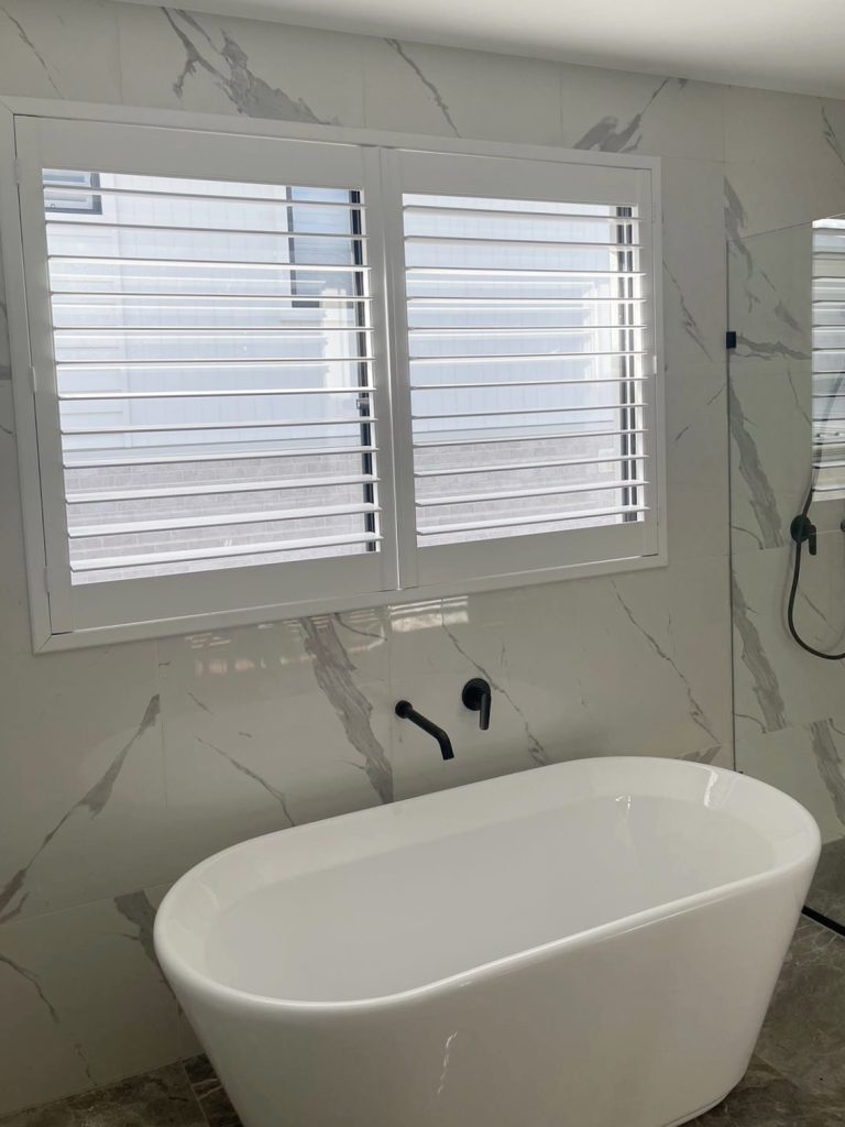 White PVC shutters elegantly installed in a bathroom
