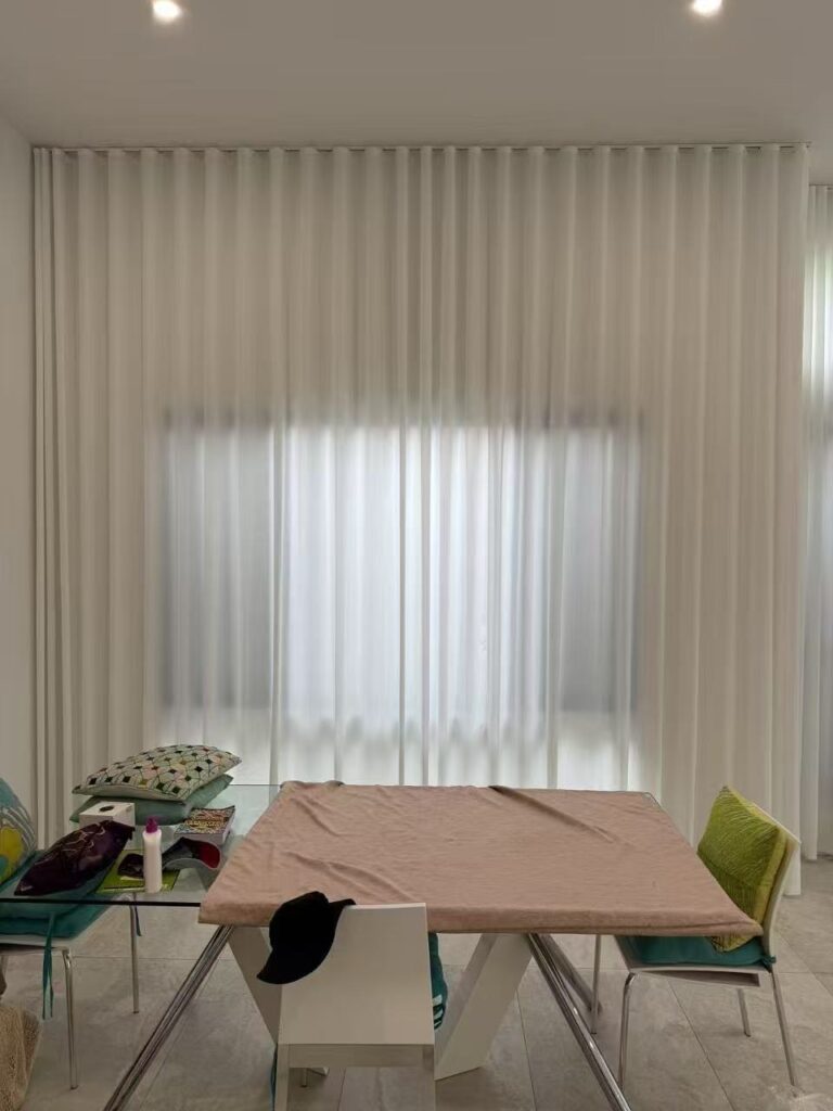 ceiling mount s fold privacy sheer installed in a dining room