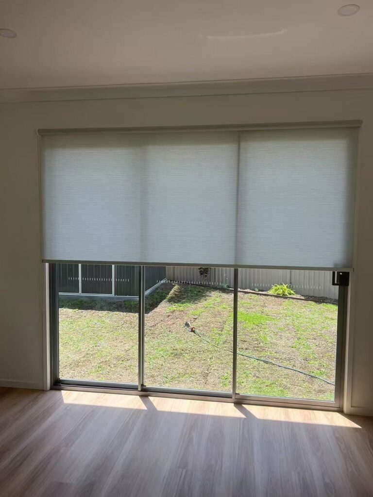 face fit semi blockout grey roller blinds installed on a sliding door