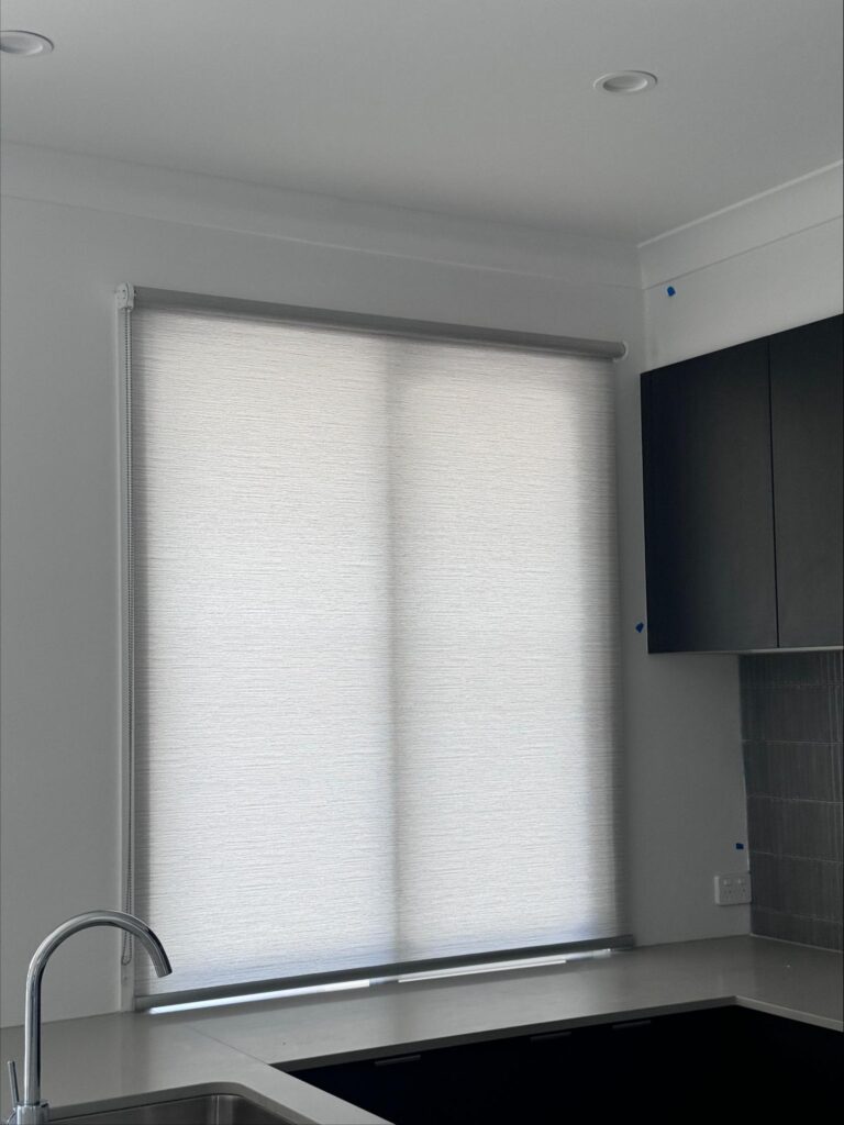 light filtering or semi blockout grey roller blinds face fit or installed on the window frame