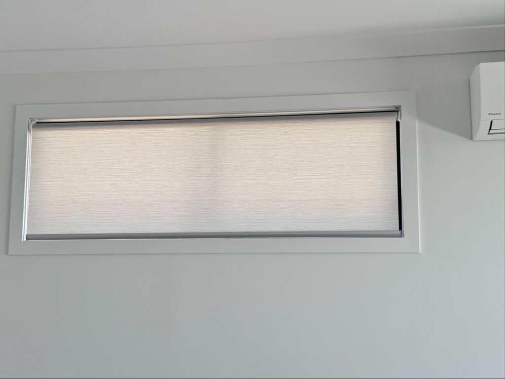 light filtering or semi blockout grey roller blinds installed in a living room