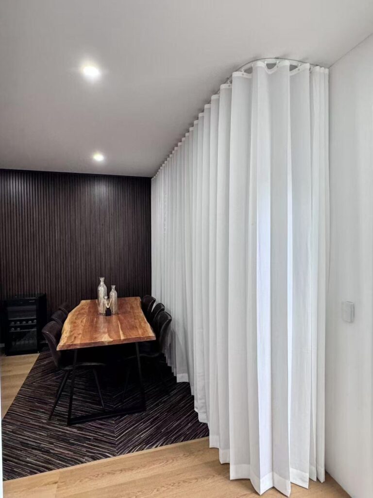 s fold privacy sheer installed with curved track in a media room