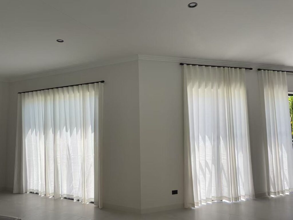 s fold privacy sheer with black roman track installed in a lving room