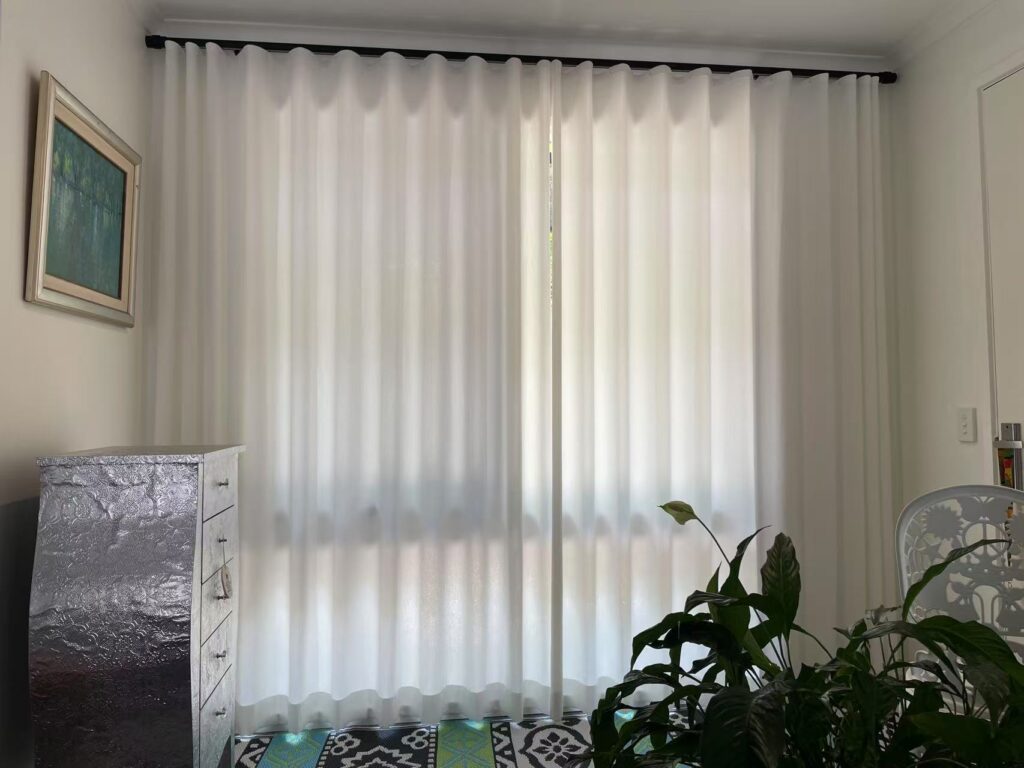 s fold privacy sheer with black roman track installed on a big window