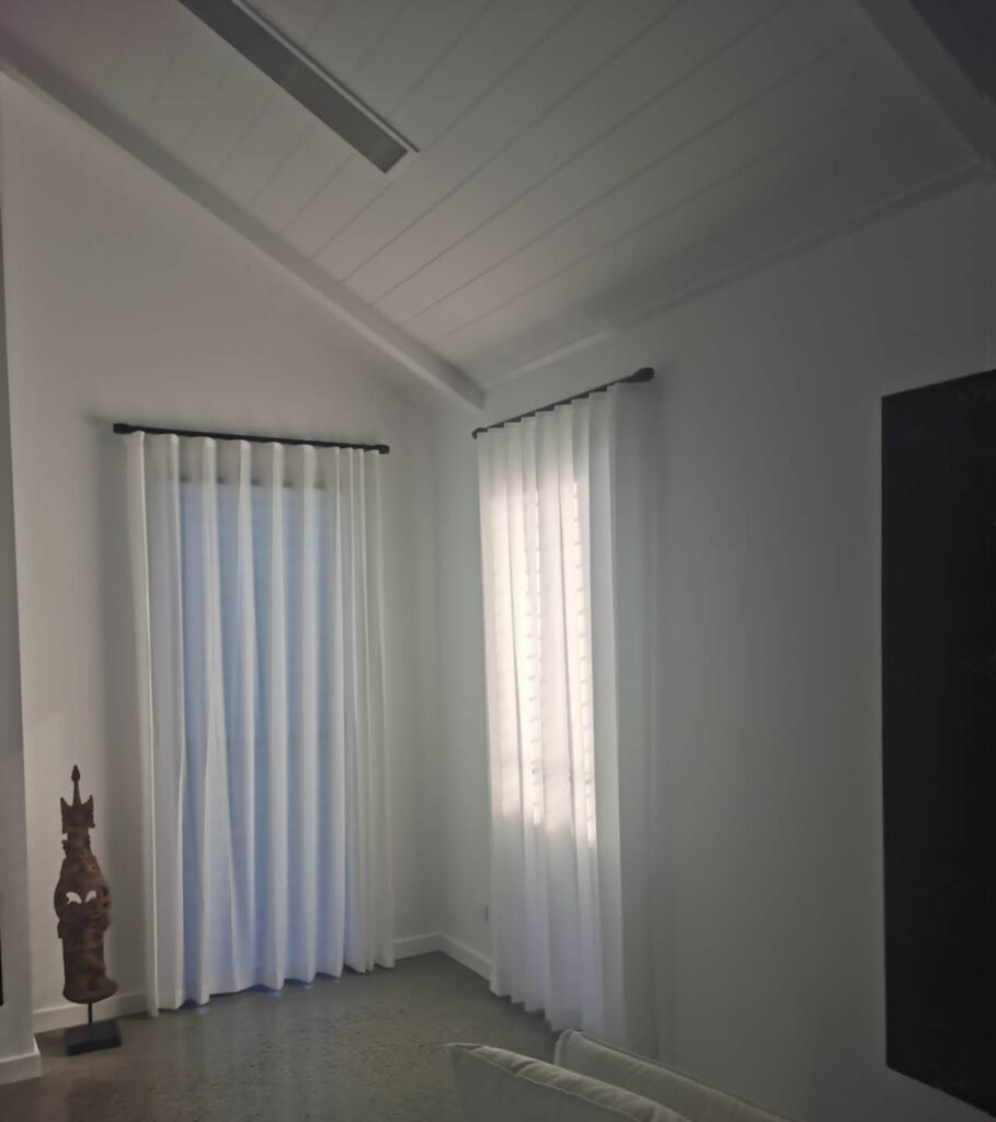 two windows installed black roma track with s fold sheer in the living room
