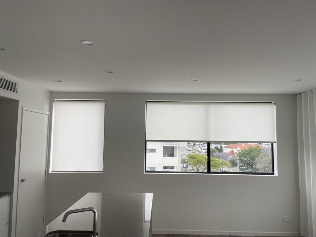 white semi blockout roller blinds installed in the kitchen and dining room