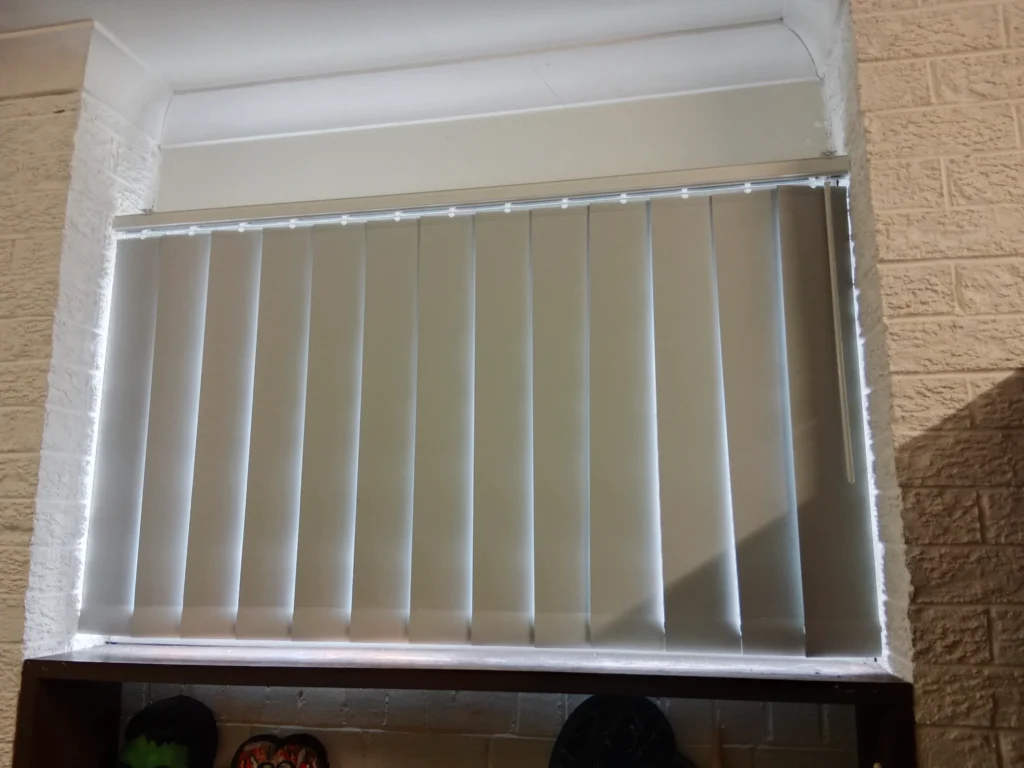 grey vertical blind installed for small window